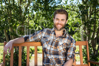 Handsome hipster relaxing in the park