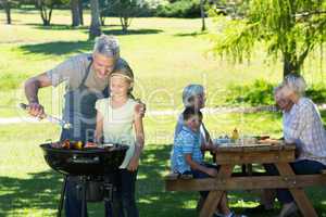 Happy father doing barbecue with his daughter