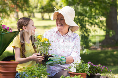 Happy grandmother with her granddaughter gardening