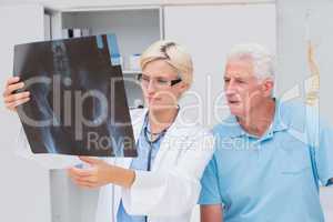 Doctor and senior patient examining x-ray