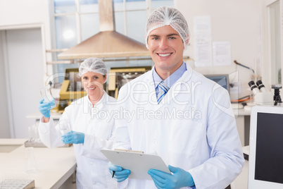 Smiling scientists looking at camera