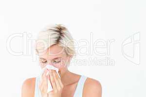 Sick woman blowing her nose