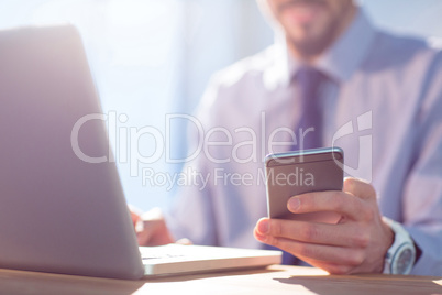 Businessman using laptop at desk