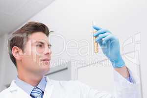 Scientist holding test tube with corn inside