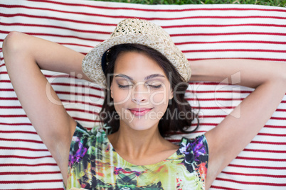 Smiling beautiful brunette lying on the blanket