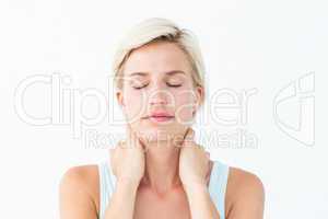 Woman with eyes closed suffering from neck ache