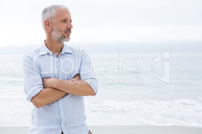 Thoughtful man standing by the sea