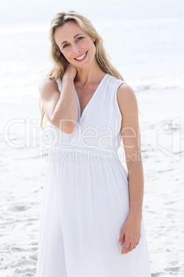 Smiling blonde in white dress looking at camera