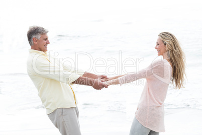 Happy couple holding hands and smiling at each other