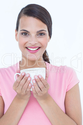 Pretty brunette holding coffee cup