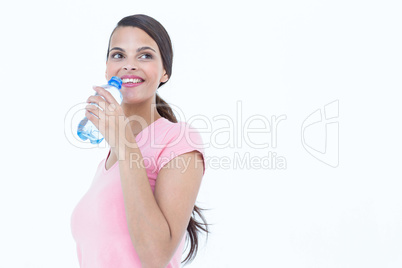 Happy woman drinking bottle of water