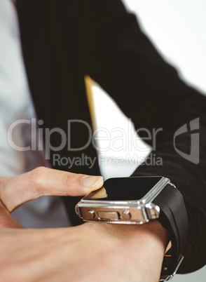 Businesswoman using a smart watch