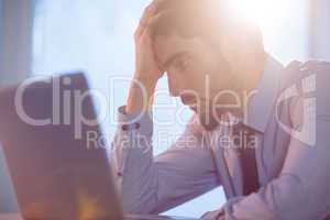 Businessman using laptop at desk