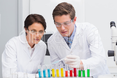 Scientists looking attentively at test tube