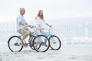 Happy couple cycling together