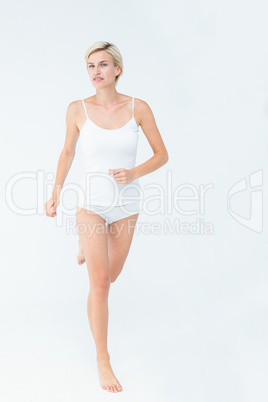 Smiling blonde woman running