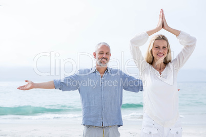 Happy couple doing yoga together