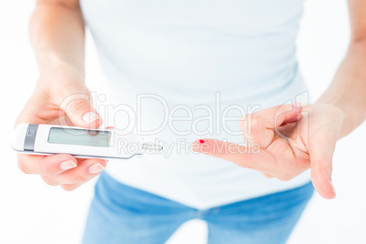 Woman testing her blood glucose level