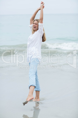 Smiling blonde having fun by the sea