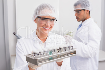 Happy scientists holding tubes