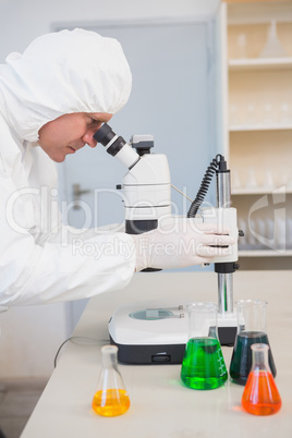 Scientist examining sample with microscope