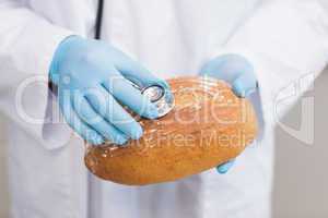 Scientist listening bread with stethoscope