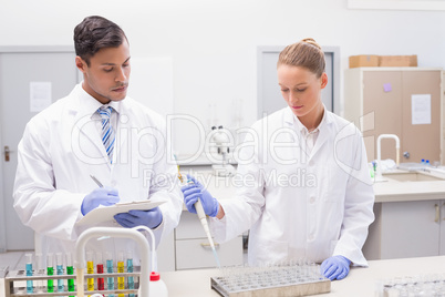 Scientists examining tubes