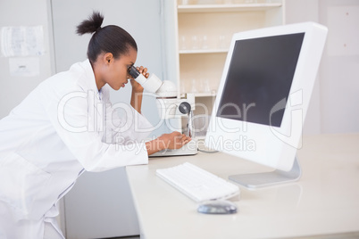 Scientist looking through a microscope