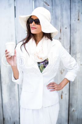 Smiling beautiful brunette wearing straw hat and sun glasses