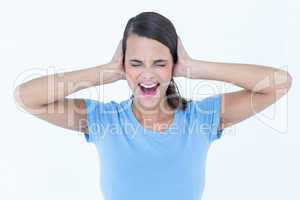 Screaming woman covering her ears