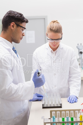 Scientists examining tubes in tray