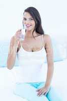 Happy woman holding glass water