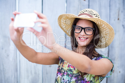 Smiling beautiful brunette taking selfie