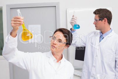 Scientists looking attentively at beakers