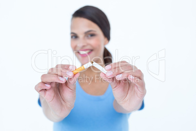 Happy woman breaking a cigarette