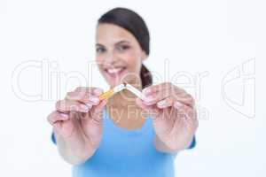 Happy woman breaking a cigarette