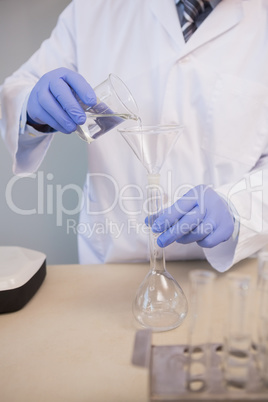 Scientist doing experimentations in flask