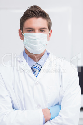 Scientist standing arms crossed and looking at camera