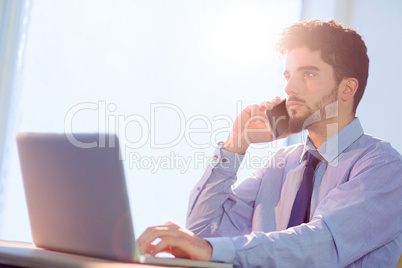 Businessman using laptop at desk