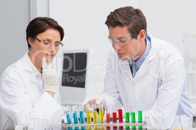 Scientists working attentively with test tube