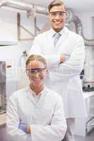 Smiling scientists looking at camera arms crossed