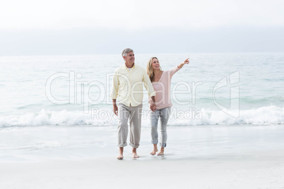 Happy couple walking by the sea