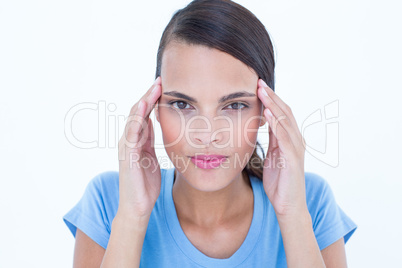 Pretty woman with headache touching her temples looking at camer