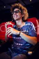 Smiling young man watching a 3d film