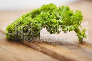 Curly parsley on wooden board