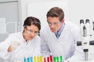 Scientists looking attentively at test tube