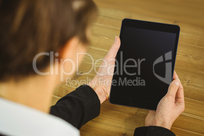 Businesswoman using tablet at desk