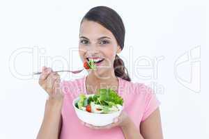 Pretty brunette eating a bowl of salad