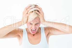 Angry blonde woman screaming and holding her head