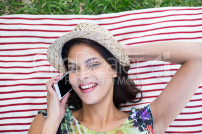 Smiling beautiful brunette lying on the blanket